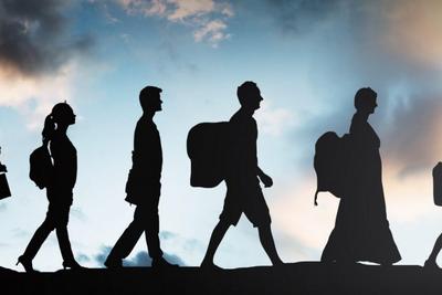 A minimalist conceptual graphic depicting the stark silhouette of figures migrating across a brightly backlit golden horizon line. The imagery serves as a powerful visual representation of youth migration, displacement, and socioeconomic journeys.