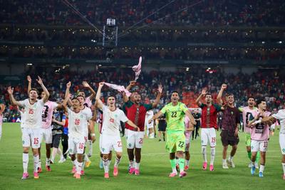 Morocco players celebrate  as Morocco qualify for the Round of 16