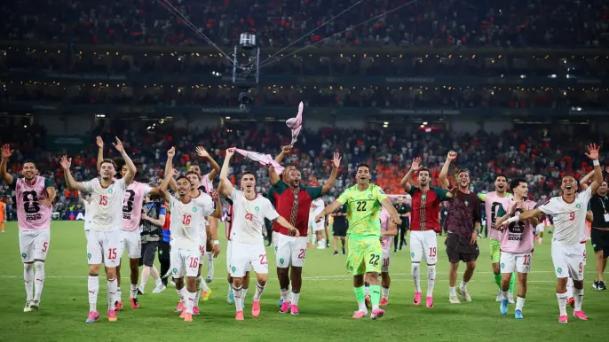 Morocco players celebrate  as Morocco qualify for the Round of 16